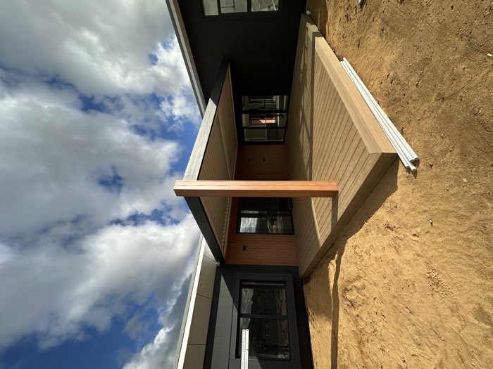 Composite deck with a louvred roof over and a hardwood post