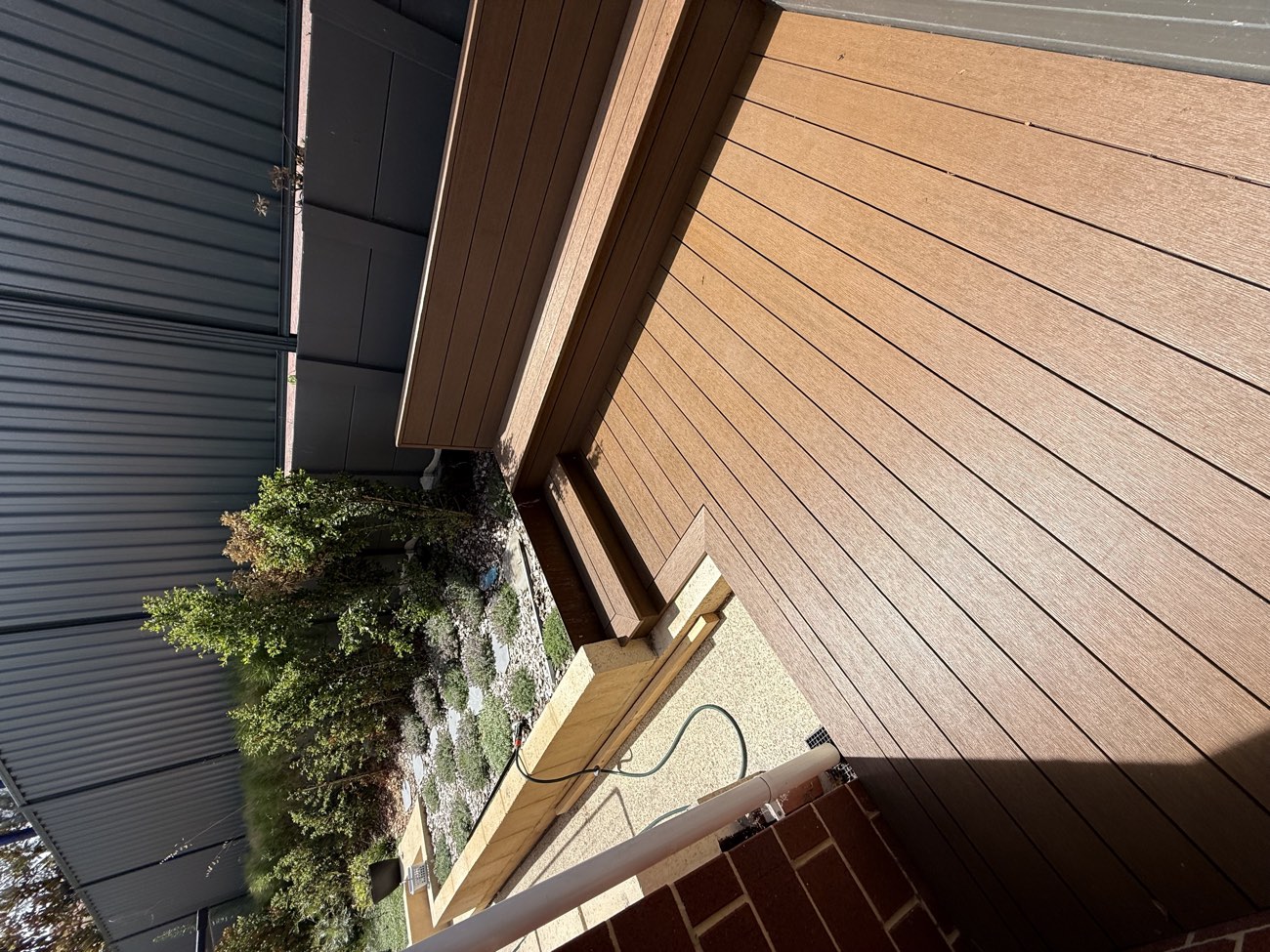 Composite deck with built-in bench seating and a planter surround