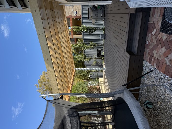 Timber pergola over a composite deck in a back garden