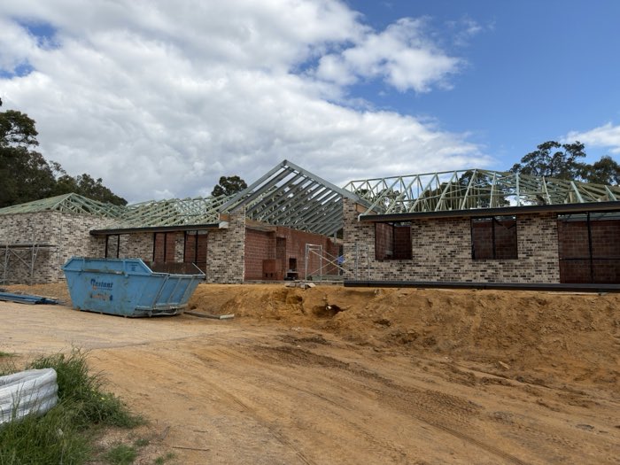 Roof frame with a steel portal and raked section on a brick home